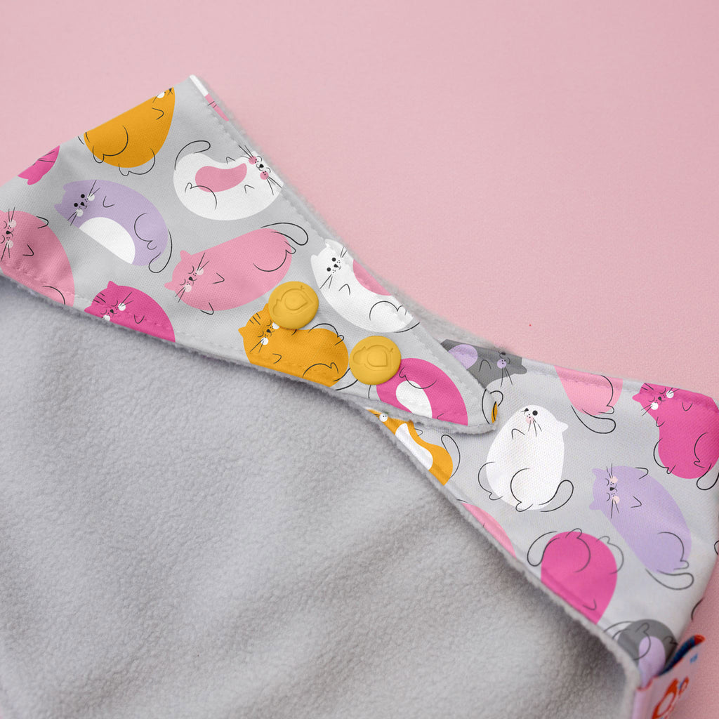 Gray fabric with colorful cat pattern on a pink background