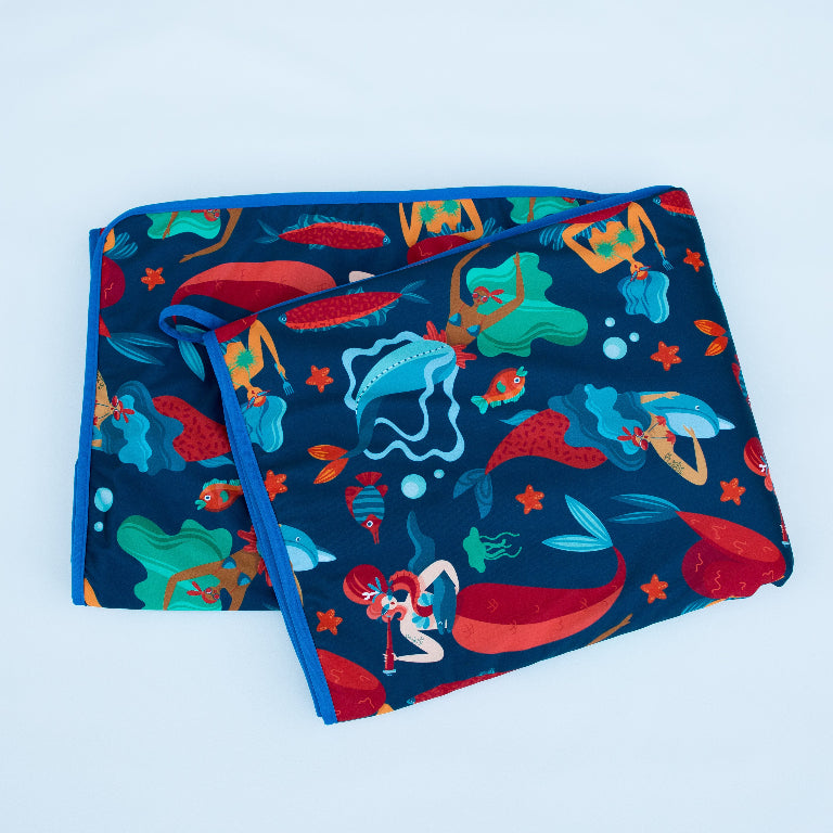 Colorful mermaid-themed fabric with underwater creatures and vibrant aquatic designs.